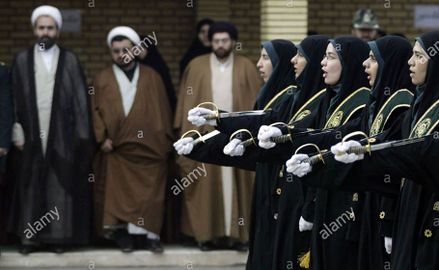 Iranian-women-police-march-as-clergymen-look-at-them-during-their-graduation-ceremony-in-tehran-iran-on-march-11-2006-upi-photomohammad-kheirkhah-TXTBG3.jpg