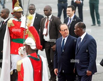 France's President Francois Hollande (2nd R) talks with Ivory Coast's President Alassane Ouattara (R) at the Felix Houphouet Boigny International Airport in Abidjan July 17, 2014.jpg