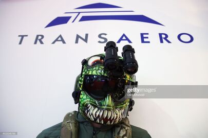 A mannequin wearing a HGU-56P rotary wing aircrew helmet, produced by Gentex Corp is displayed on a stand on day four of the Farnborough International Airshow on July 16, 2014 in Farnborough, England.jpg