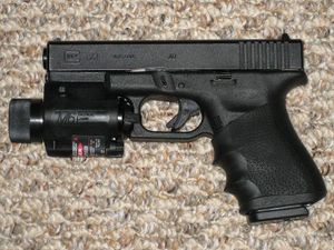 800px-Glock Model 23 with tactical light and laser sight..jpg
