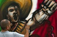 An artist works on his painting of a Mexican revolutionary, during the Independence Bicentenary and Revolution Centenary contest, organized by local authorities, in Mexico City, on September 11, 2010..jpg