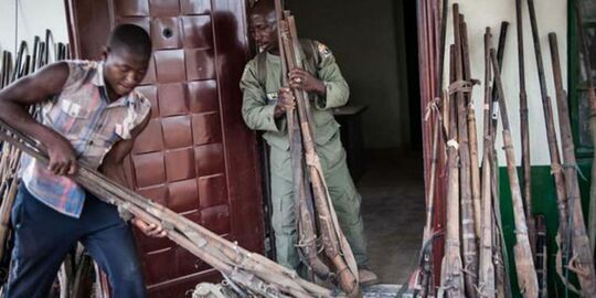 Ranger Hashumu Abdullahi (left) and his assistant, unpacking some of the over 200 confiscated locally made Dane gun at Yankari Game Reserve in northeastern Nigeria.jpg