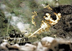 M4A3E8 Шерман применяет огнемет против оборонительного сооружения в горе. Корея, недалеко от реки Хан, 30 марта 1952.jpg