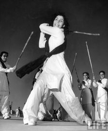 Pakistani members of the Sind Muslim Women's National Guard practicing combat w. bamboo lathi sticks traditionally used by the Indian police 3.jpg
