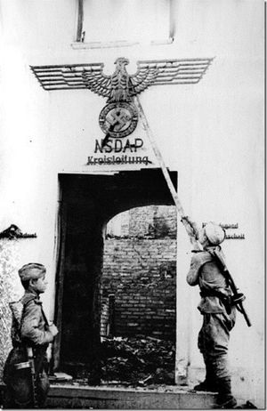 Советские солдаты срывают символы немецкой национал-социалистической партии. ВОВ. 1944 г..jpg