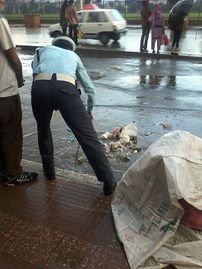 Traffic Police man removing plastics from blocked drainage..jpg