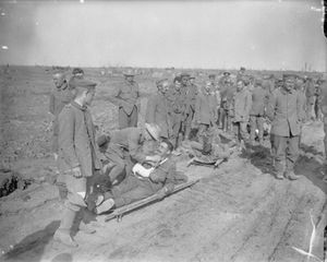 The Battle of Morval, Somme, France. A group of German prisoners and wounded Grenadier Guardsmen on stretchers are offered cigarettes1916.jpg