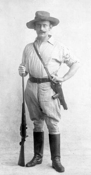 German colonial administrator Carl Peters with a Borchardt C93 and a Lee-Speed Sporter rifle. C.1893-1900.jpg