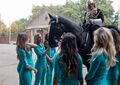 Members of the Miami Dolphins cheer leaders squad meet a rider and a horse from the the Household Cavalry Regiment 27 сентября 2017.jpg