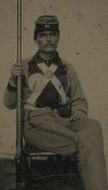 800px-(Corporal John Wesley Edmunds of Co. B, 11th Virginia Infantry Regiment in uniform with secession badge and breastplate holding musket) (LOC) (14585730743).jpg
