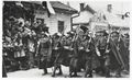 March down a street in Sanok past a swastika 1936.jpg