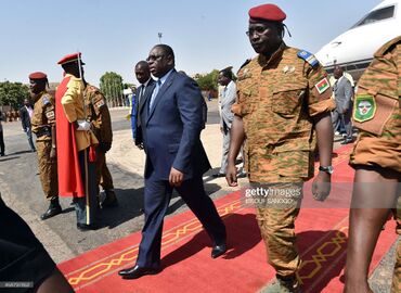 Burkina Faso's army-appointed leader Lieutenant-Colonel Isaac Zida (R) walks with president Macky Sall of Senegal (L) on November 11, 2014 at Ouagadougou airport in Burkina Faso.jpg