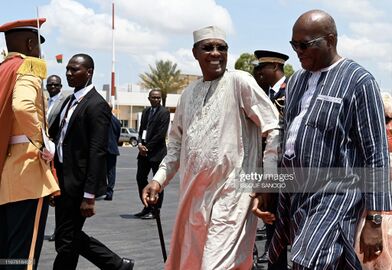 Chadian President Idriss Deby (L) is welcomed by his Burkina Faso counterpart Roch Marc Christian Kabore upon his arrival at Ouagadougou Airport on September 13, 2019.jpg
