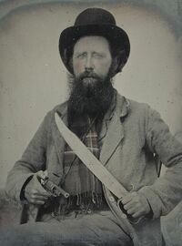 800px-Private Thomas F. Bates of D Company, 6th Texas Infantry Regiment, with D guard Bowie knife and John Walch pocket revolver LCCN2012645977.jpg