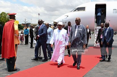 Malian president Ibrahim Boubacar Keita (L) is welcomed by his Burkina Faso counterpart Roch Marc Christian Kabore upon his arrival at Ouagadougou airport on September 13, 2019.jpg