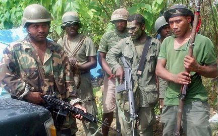 Eight col Malaita Eagle Force MEF rebels stand guard at their post in Honiara 12 June 2000. Credit Arthur WateSolomon StarAFP.jpg
