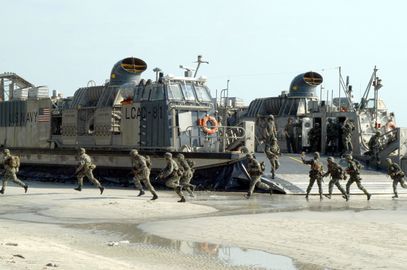 US Navy 040720-N-4104L-030 Landing force members of the Royal Malay Regiment (RMR) hit the beach running from a U.S. Navy Landing Craft Air Cushioned (LCAC).jpg