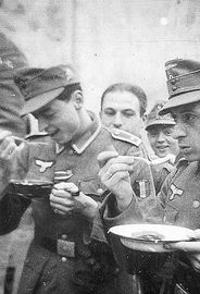 Tasting the soup. On the left Hubert Van Eyser who was to be killed in action at Cherkassy as a platoon leader in the 1st Company.jpg