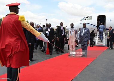 Liberia's President George Weah (C) is welcomed by his Burkina Faso counterpart Roch Marc Christian Kabore upon his arrival at Ouagadougou airport on September 13, 2019.jpg