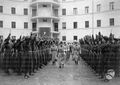 Mussolini, accompagnato dal generale Luigi Russo e da altri uffiiciali della milizia, sfila tra due ali di moschettieri del duce durante la cerimonia per l'annuale della costituzione 11.02.1937.jpg