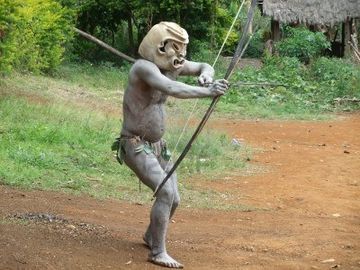 11786137-papua-new-guinea--september-16-mudman-warrior-aims-with-his-bow-at-goroka-tribal-festival-papua-new-.jpg