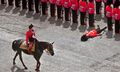 A guardsman collapses in the heat, during Trooping The Colour (1970)..jpg