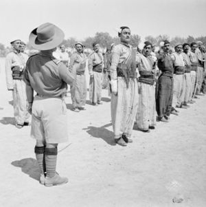 Recruits in the Iraq Levies are shown here drilling on the square, still wearing their tribal dress..jpg