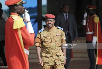 President Faure Gnassingbe of Togo (C) walks with Burkina Faso's army-appointed leader Lieutenant-Colonel Isaac Zida (2e-L) at Ouagadougou airport on November 11, 2014 during president Faure's welcome ceremony 1.jpg