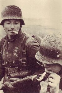 Солдаты вермахта прикуривают от огнемёта Flammenwerfer 35, Вторая мировая война.jpg
