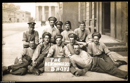 Bermondsey B'hoys A group of men from the Grenadier Guards sit behind a hastily-drawn sign.jpg