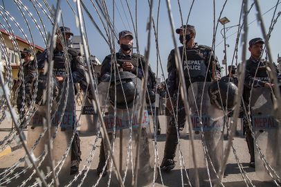 Nepali police forces stand behind a razor wired barricade set up to impede access to protesters to the Constituent Assembly a day ahead of the deadline for a new constitution on January 21, 2015 in Kathmandu, Nepal..jpg