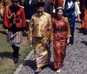 Palden Thondup Namgyal, King of Sikkim, and Hope Cooke, Queen of Sikkim, in brocaded dress, walking to the palace temple during the King's birthday celebration. 1971.jpg