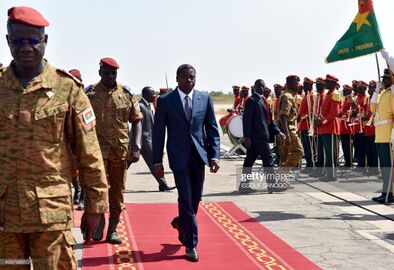 President Faure Gnassingbe of Togo (C) walks with Burkina Faso's army-appointed leader Lieutenant-Colonel Isaac Zida (2e-L) at Ouagadougou airport on November 11, 2014 during president Faure's welcome ceremony.jpg